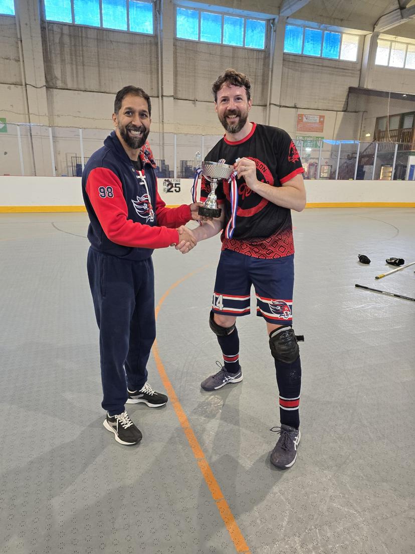 Travis accepting the winning trophy from Samir
